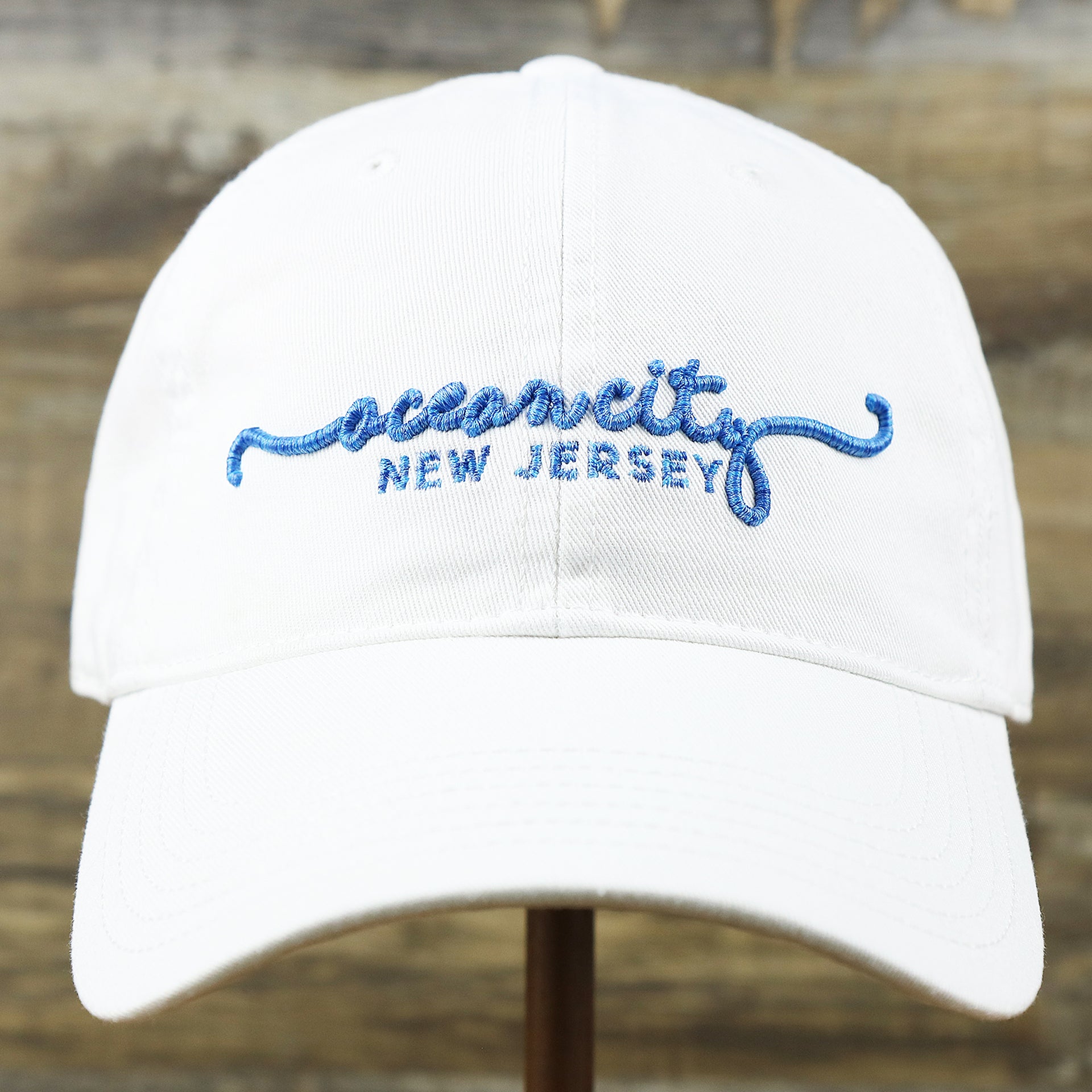 The front of the OCNJ New Jersey Ocean City Cursive Wordmark Dad Hat | White Dad Hat 