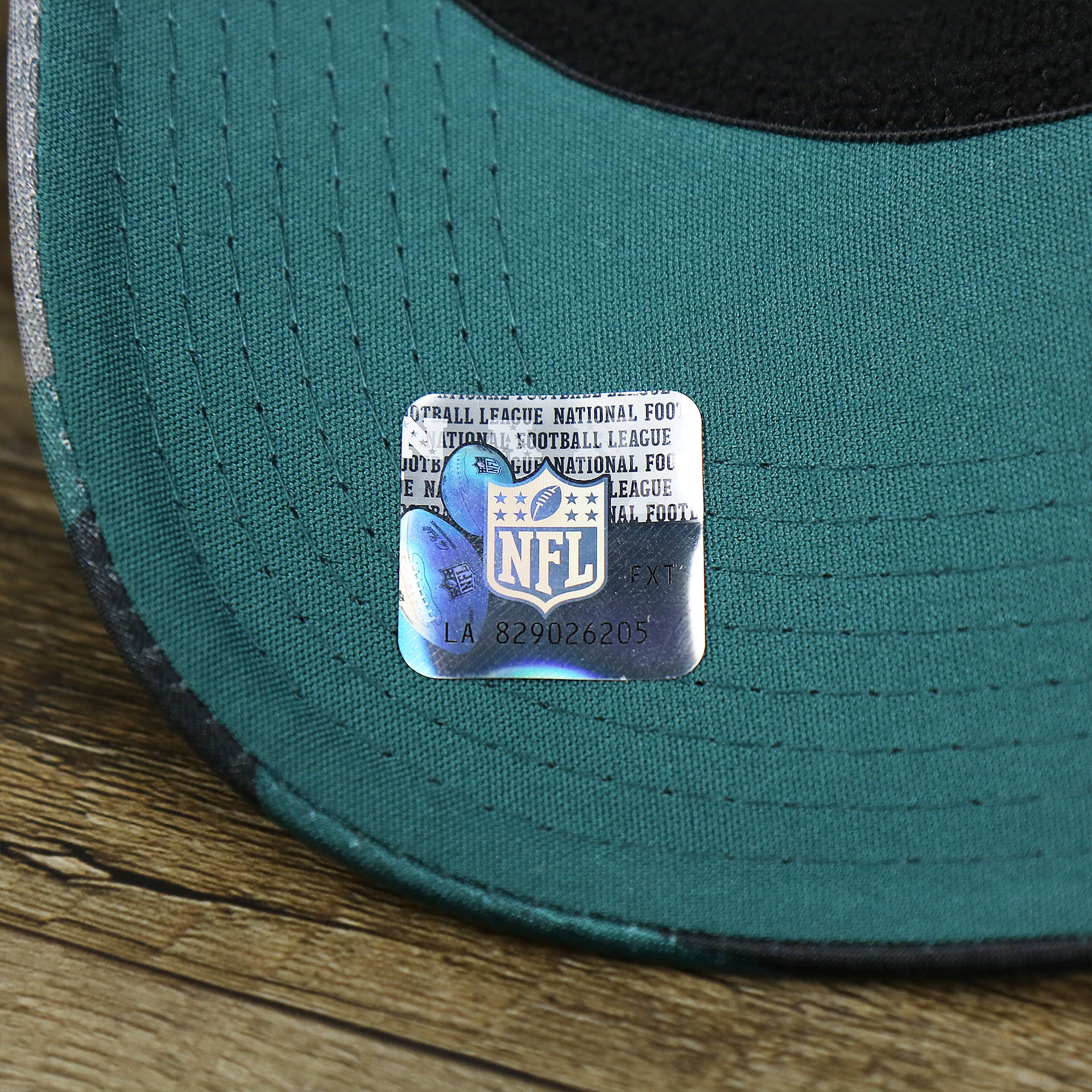 The NFL Sticker on the Philadelphia Eagles Summer Training 2022 Camo 39Thirty FlexFit Cap | Midnight Green Camo 39Thirty Cap