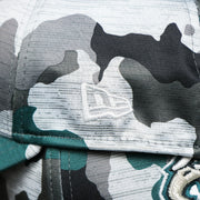 The New Era Logo on the Philadelphia Eagles Summer Training 2022 Camo 39Thirty FlexFit Cap | Midnight Green Camo 39Thirty Cap