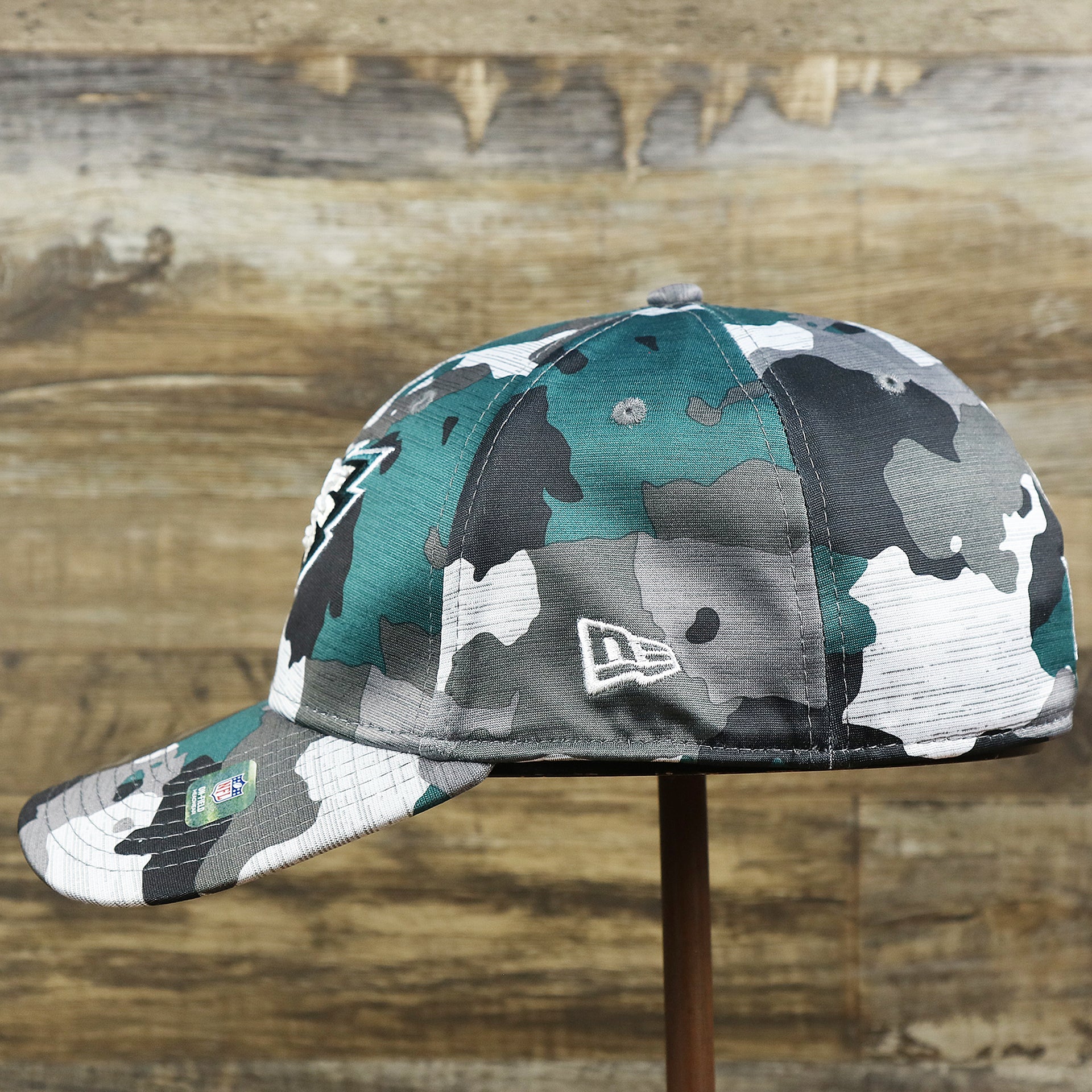 The wearer's left on the Philadelphia Eagles Summer Training 2022 Camo 39Thirty FlexFit Cap | Midnight Green Camo 39Thirty Cap