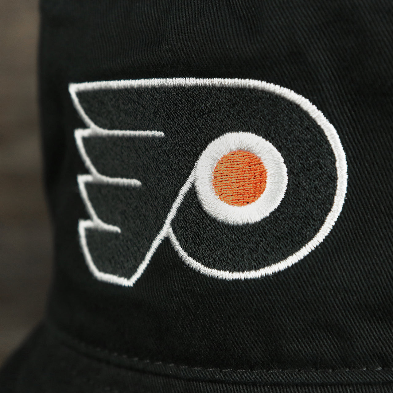 The Flyers Logo on the Philadelphia Flyers Logo Orange Undervisor Bucket Hat | Black Bucket Hat
