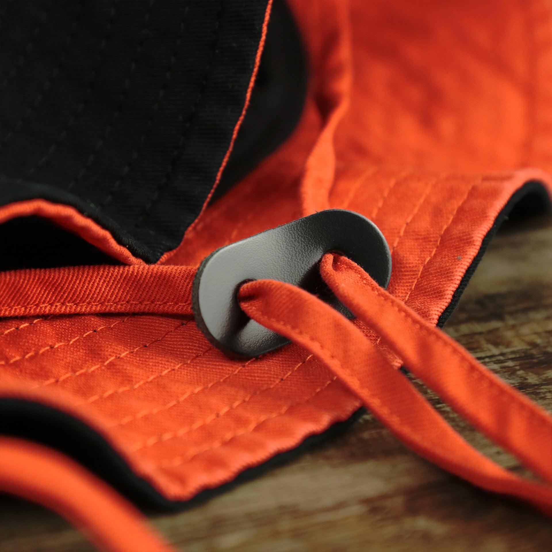 The Chin Strap on the Philadelphia Flyers Logo Orange Undervisor Bucket Hat | Black Bucket Hat
