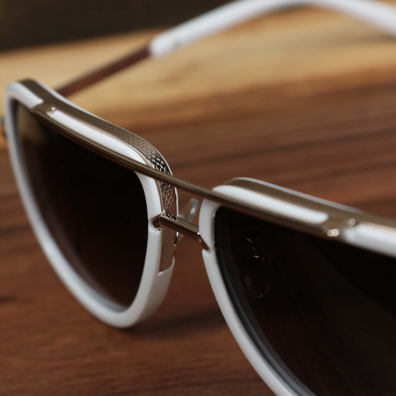 The bridge on the Round Frame Black Lens Luxury Sunglasses with White Gold Frame