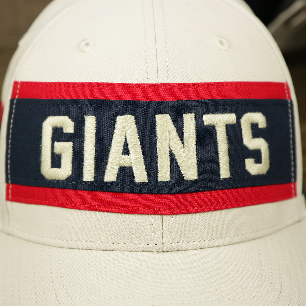 The Giants Wordmark on the Throwback New York Giants Striped Wordmark Legacy Giants Side Patch Crossroad Dad Hat | Bone Dad Hat