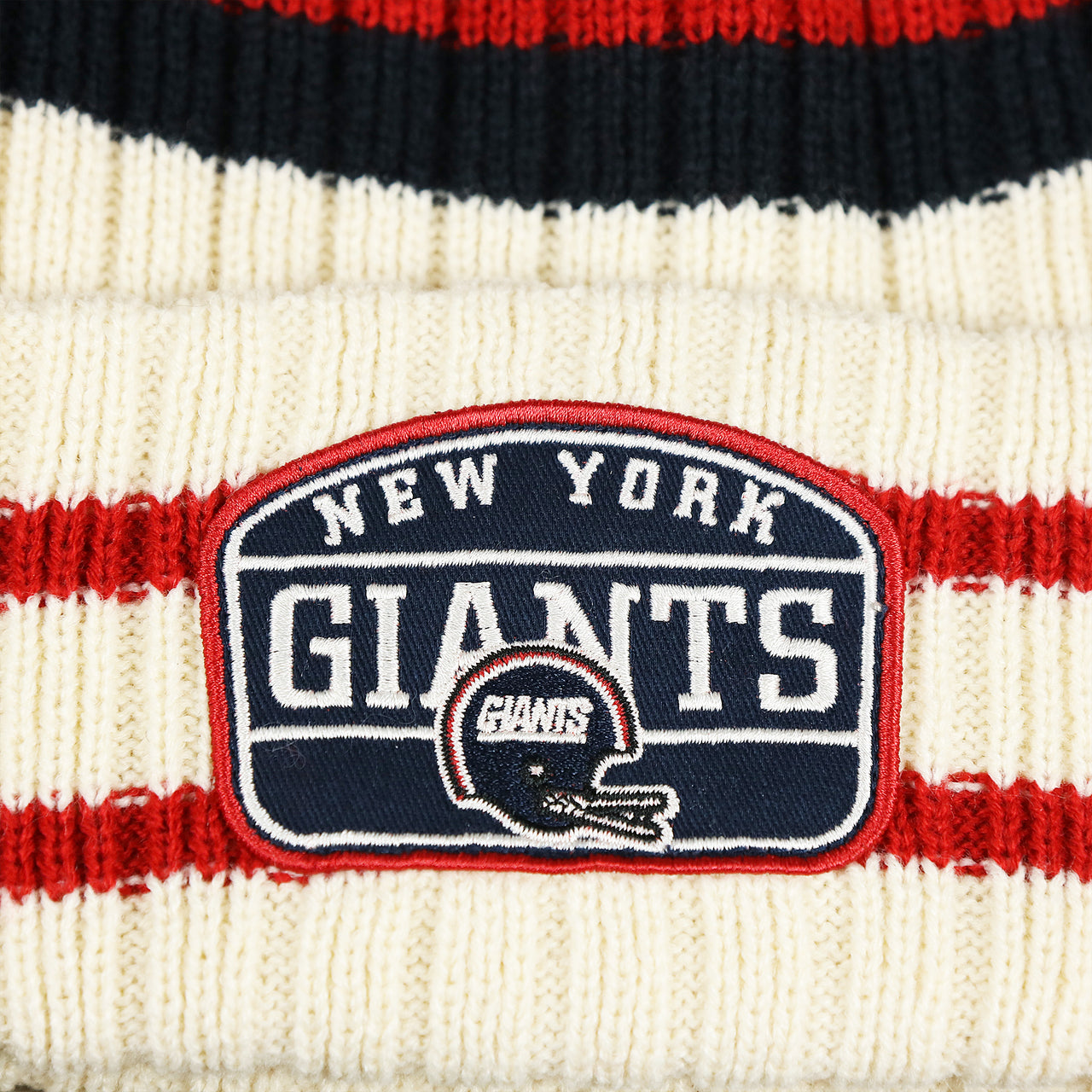 The Giants Patch on the Throwback New York Giants Legacy Giants Helmet Patch Pom Pom Beanie | Natural Beanie