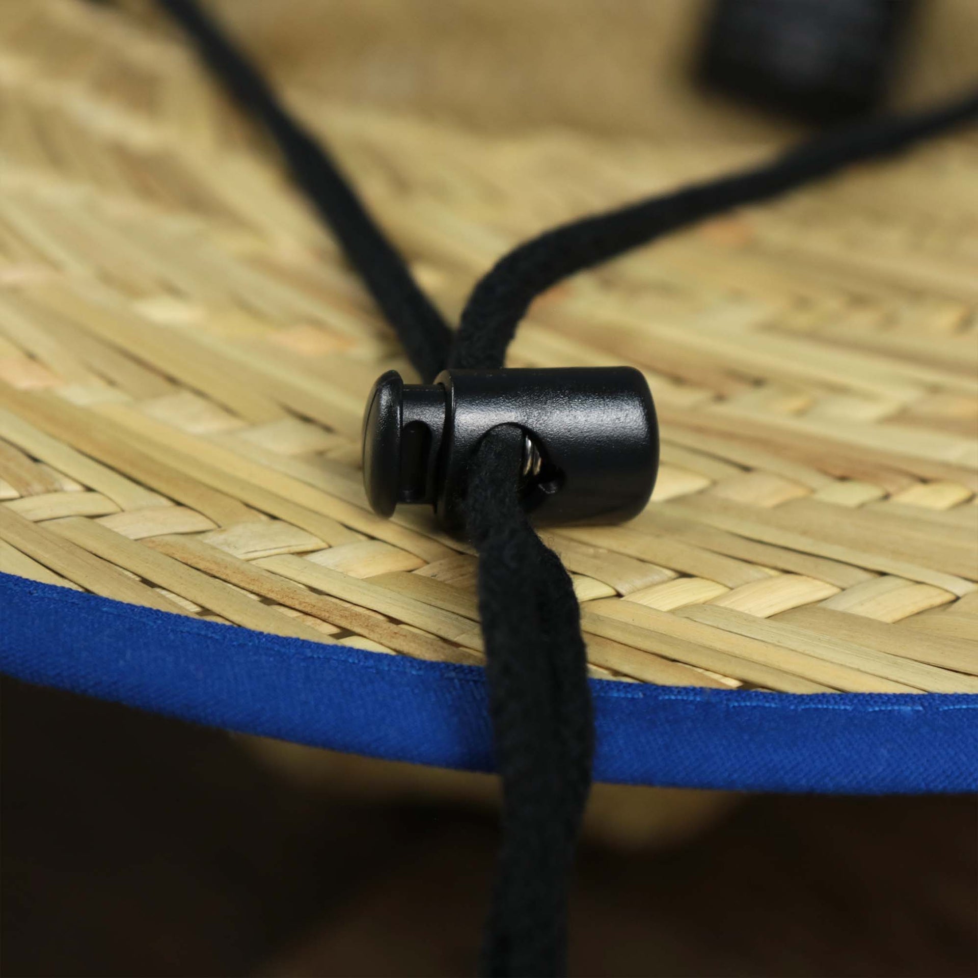 The black adjustable chin strap on the New York Giants On Field 2021/2022 Summer Training Straw Hat | New Era OSFM