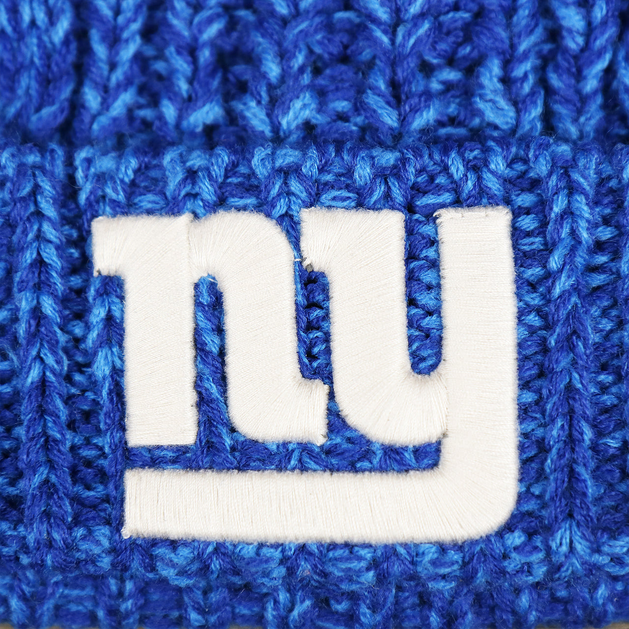 The Giants logo on the Women’s New York Giants Logo Meeko Pom Pom Beanie | Royal Blue Women’s Beanie