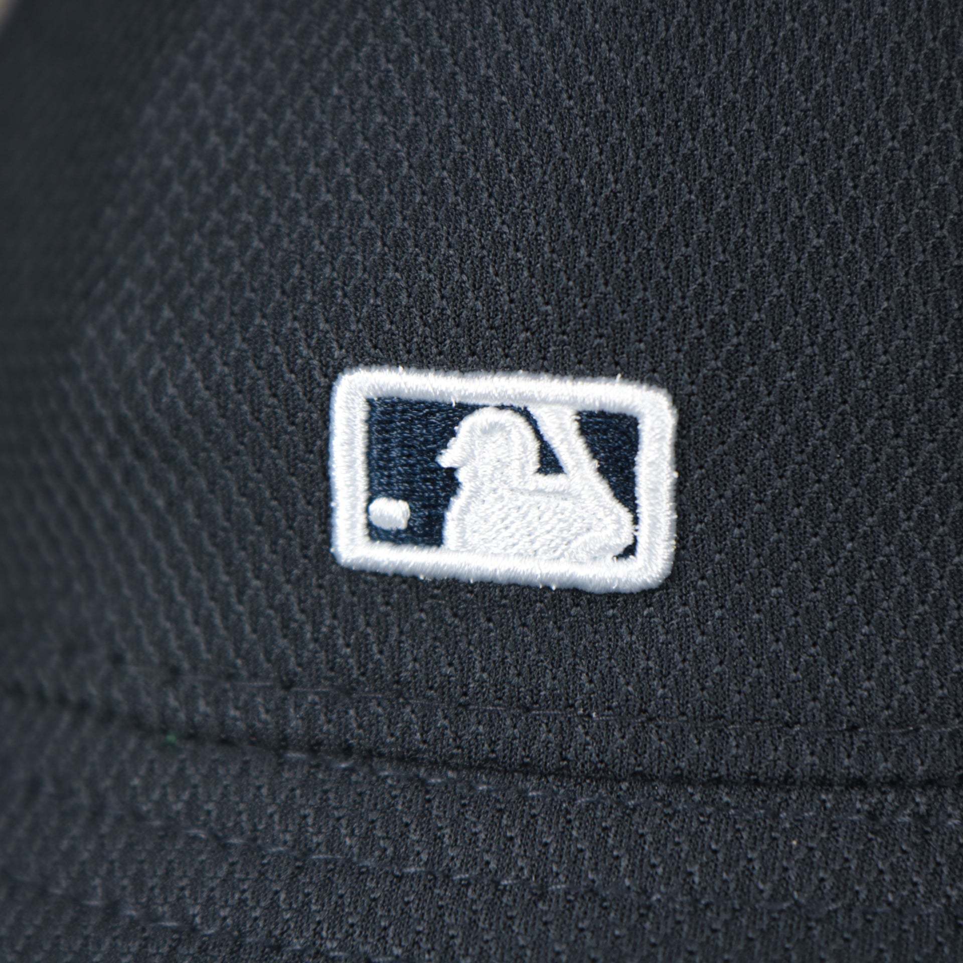 A close up of the MLB Batterman logo on the New York Yankees MLB 2022 Spring Training Onfield Bucket Hat