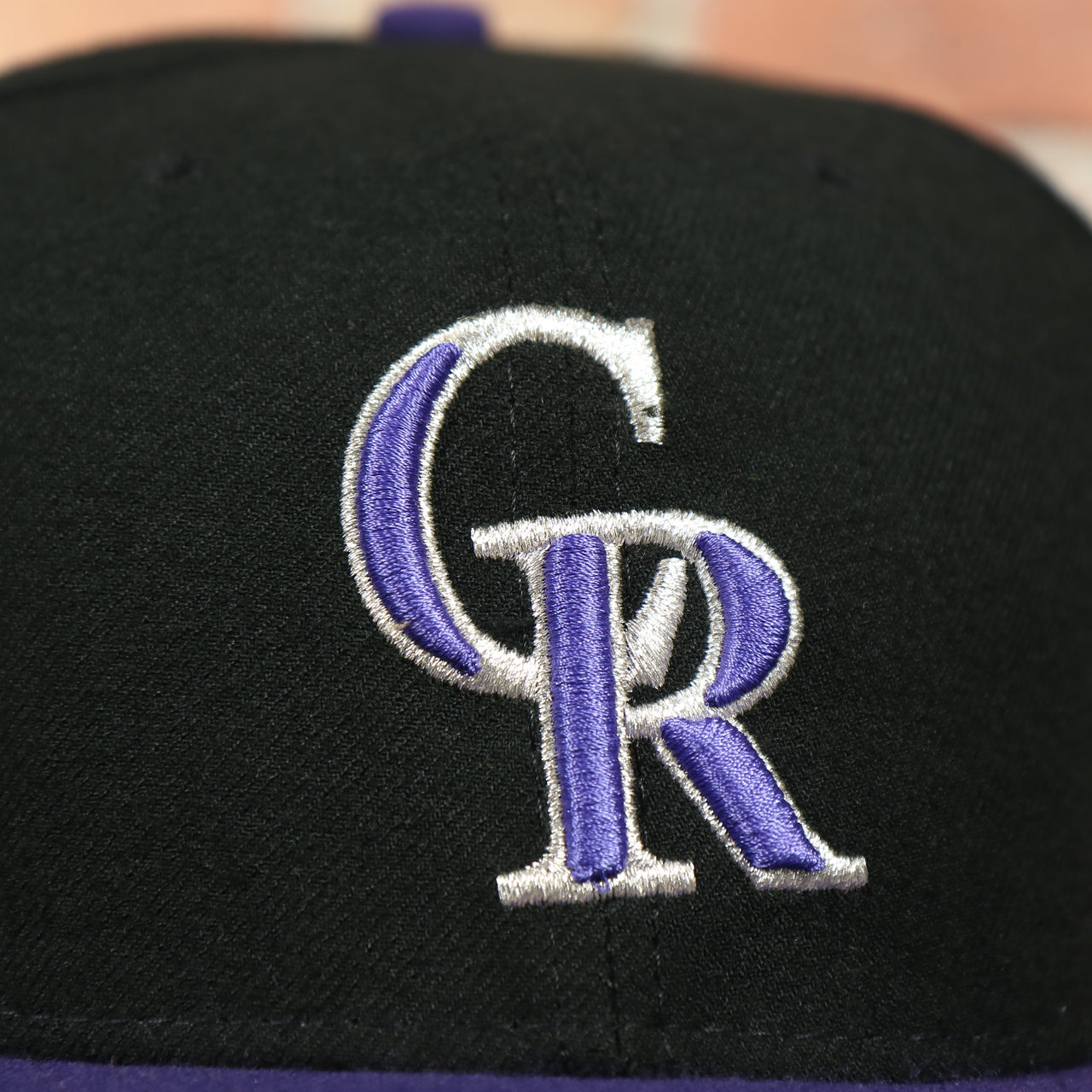 rockies logo on the Colorado Rockies MLB On-Field 59FIFTY Black and Purple Fitted Cap