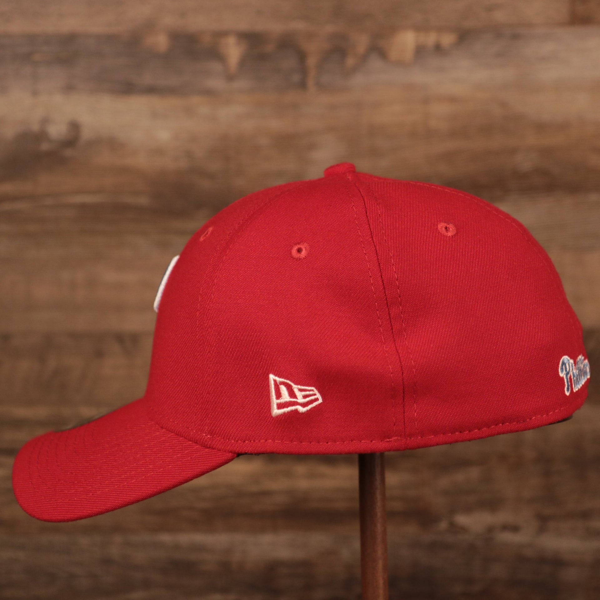 The white New Era patch on the left side of the Philadelphia Phillies red MLB on field fathers day 39thirty flexfit cap.
