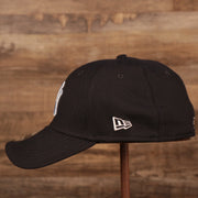 The white New Era patch on the left side of the New York Yankees navy blue MLB on field fathers day 39Thirty flexfit cap.