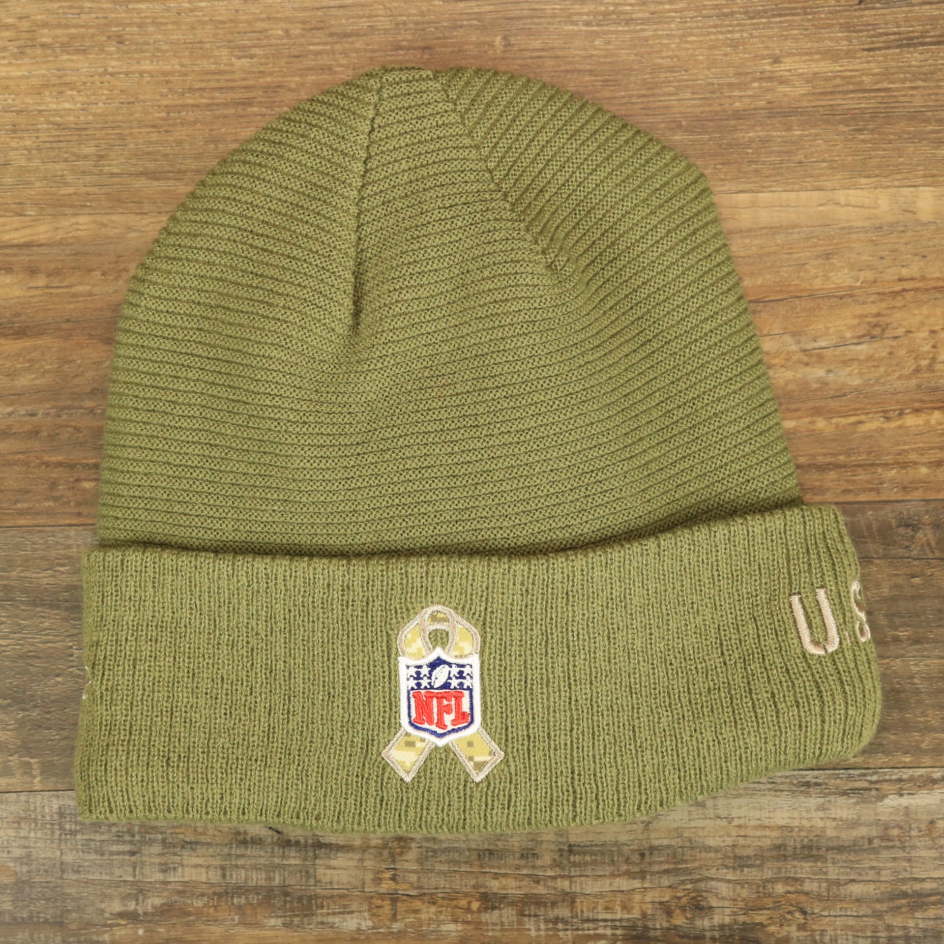 The backside of the Philadelphia Eagles Salute To Service Ribbon Rubber Military Eagles Patch On Field NFL Beanie | Military Green Beanie