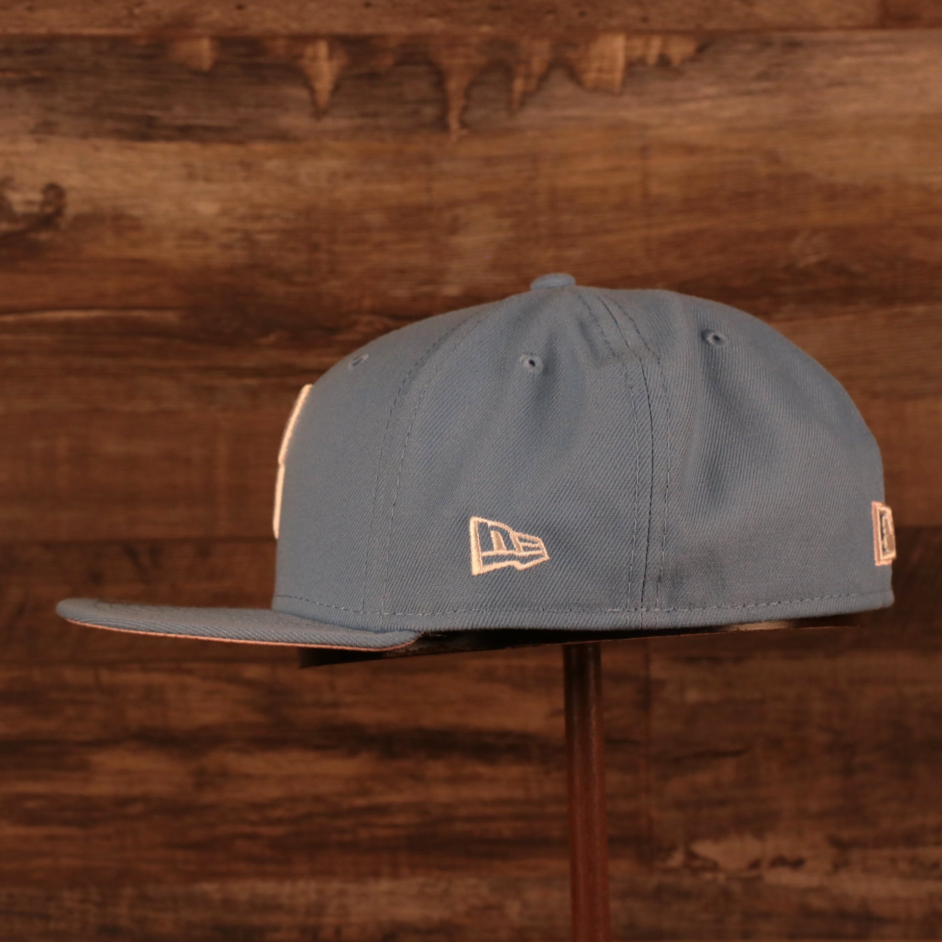 Wearer's left on the Philadelphia Phillies 1996 All Star Game Icy Blue Pink Bottom Side Patch 59Fifty Fitted Cap