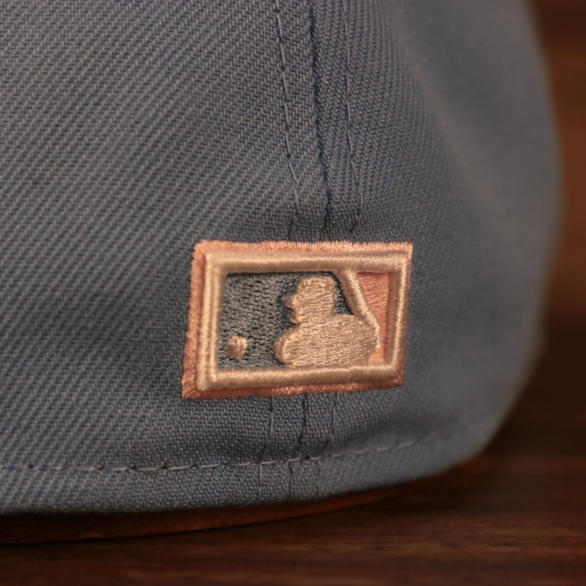Close up of the MLB Batterman logo on the back of the Philadelphia Phillies 1996 All Star Game Icy Blue Pink Bottom Side Patch 59Fifty Fitted Cap