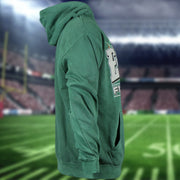 wearers right side of the Philadelphia Eagles Sun Fade Pierce Kelly Green Pullover Hoodie | Elm Green