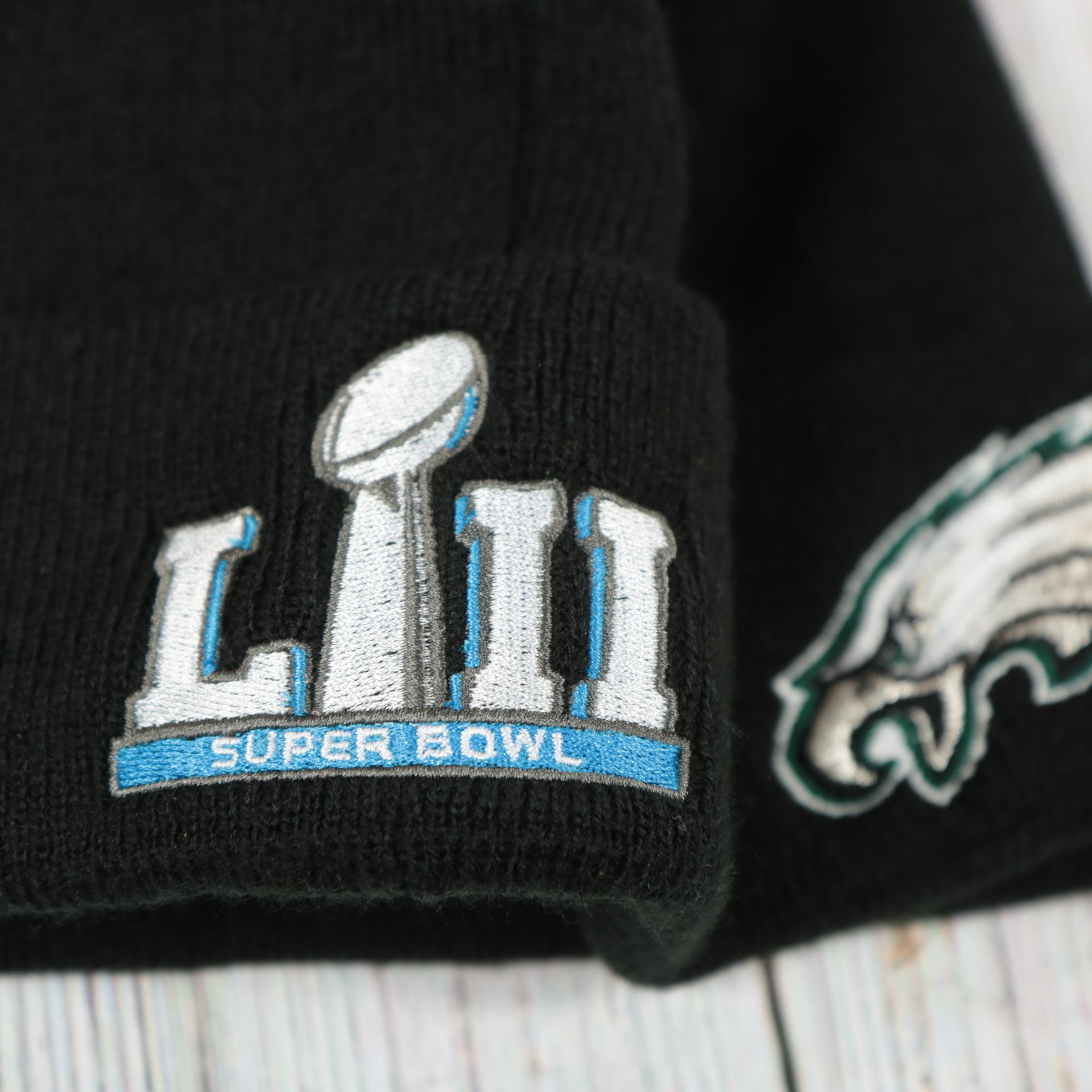 superbowl patch on the Philadelphia Eagles Super Bowl LII Patch Pom Pom Beanie | Midnight Green, Black, And White Striped Beanie