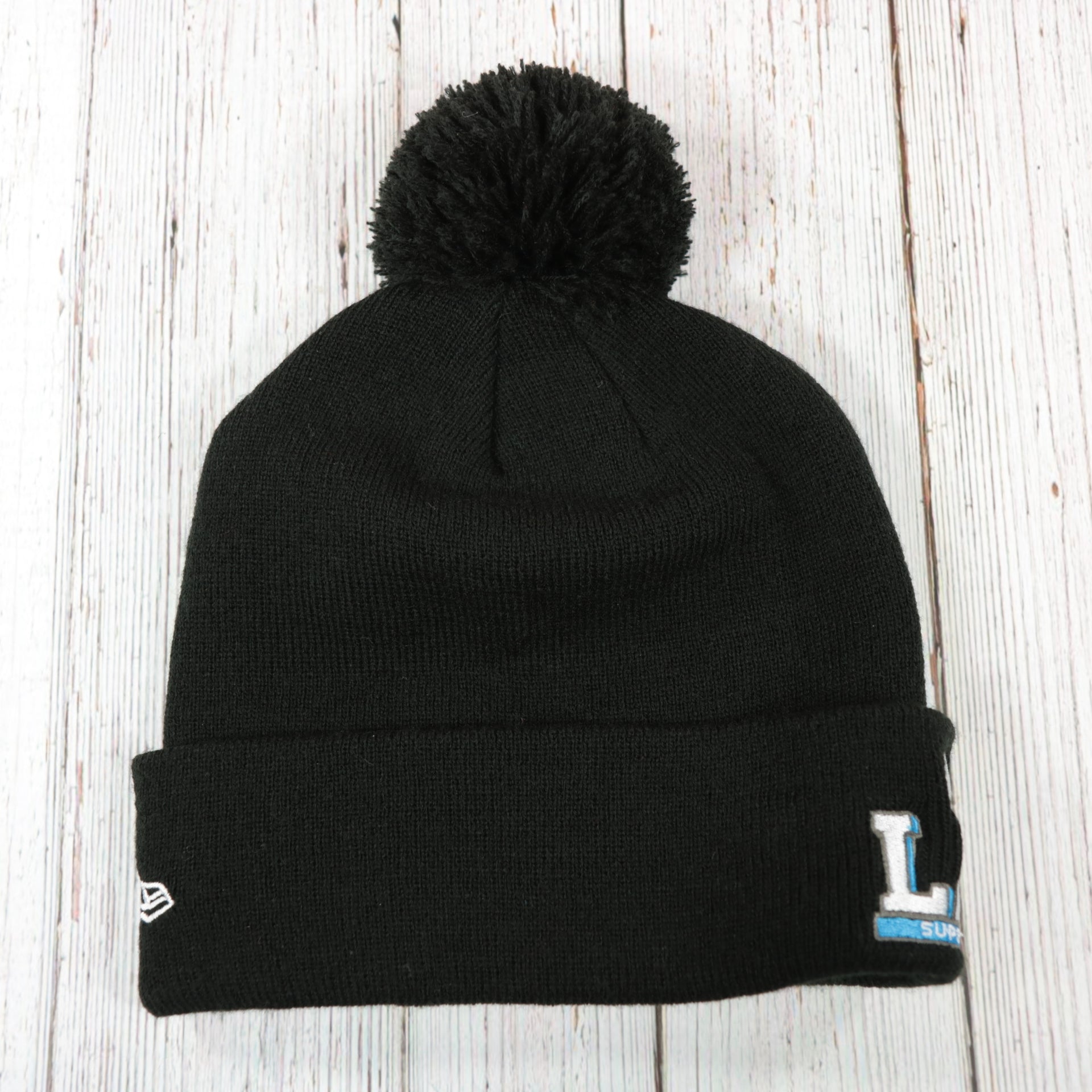 back side of  the Philadelphia Eagles Super Bowl LII Patch Pom Pom Beanie | Midnight Green, Black, And White Striped Beanie