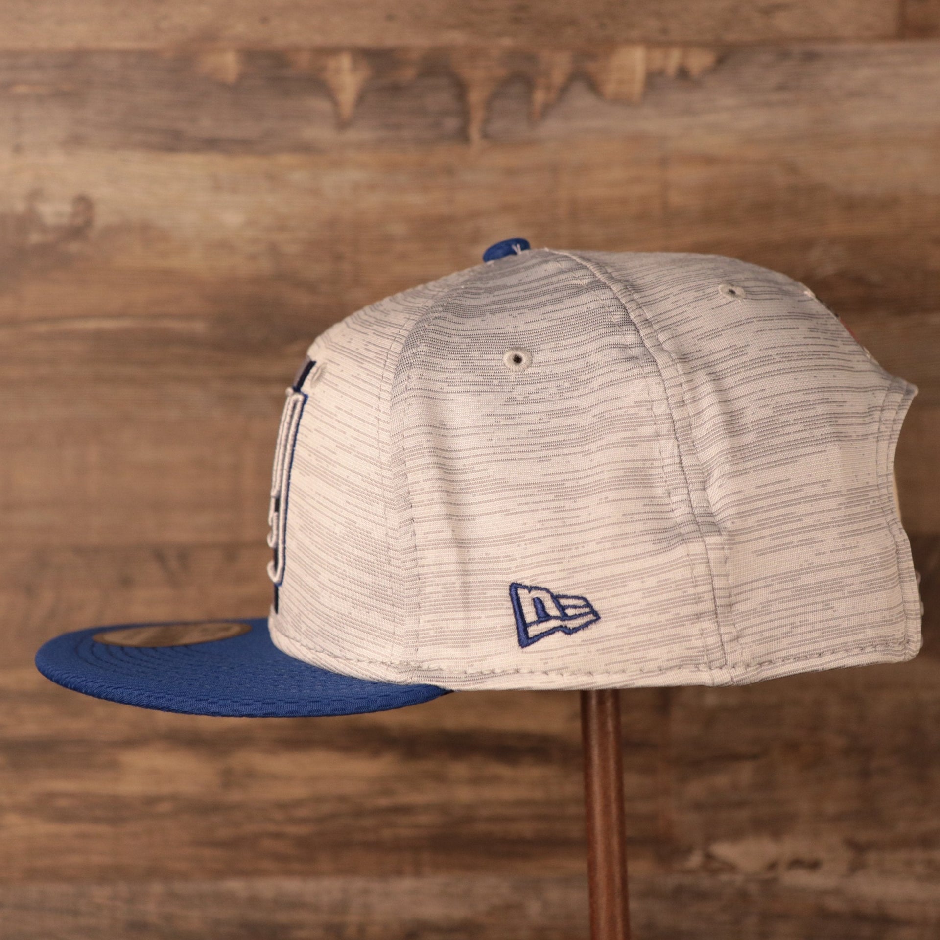 The New Era royal blue patch on the side of the 2021 nfl on field snapback hat.