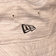 A closeup shot of the New Era patch on the side of the gray carolina panthers 2021 nfl training bucket hat by New Era.