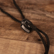 A closeup shot of the adjustable strings of the gray 2021 nfl atlanta falcons training bucket hat by New Era.