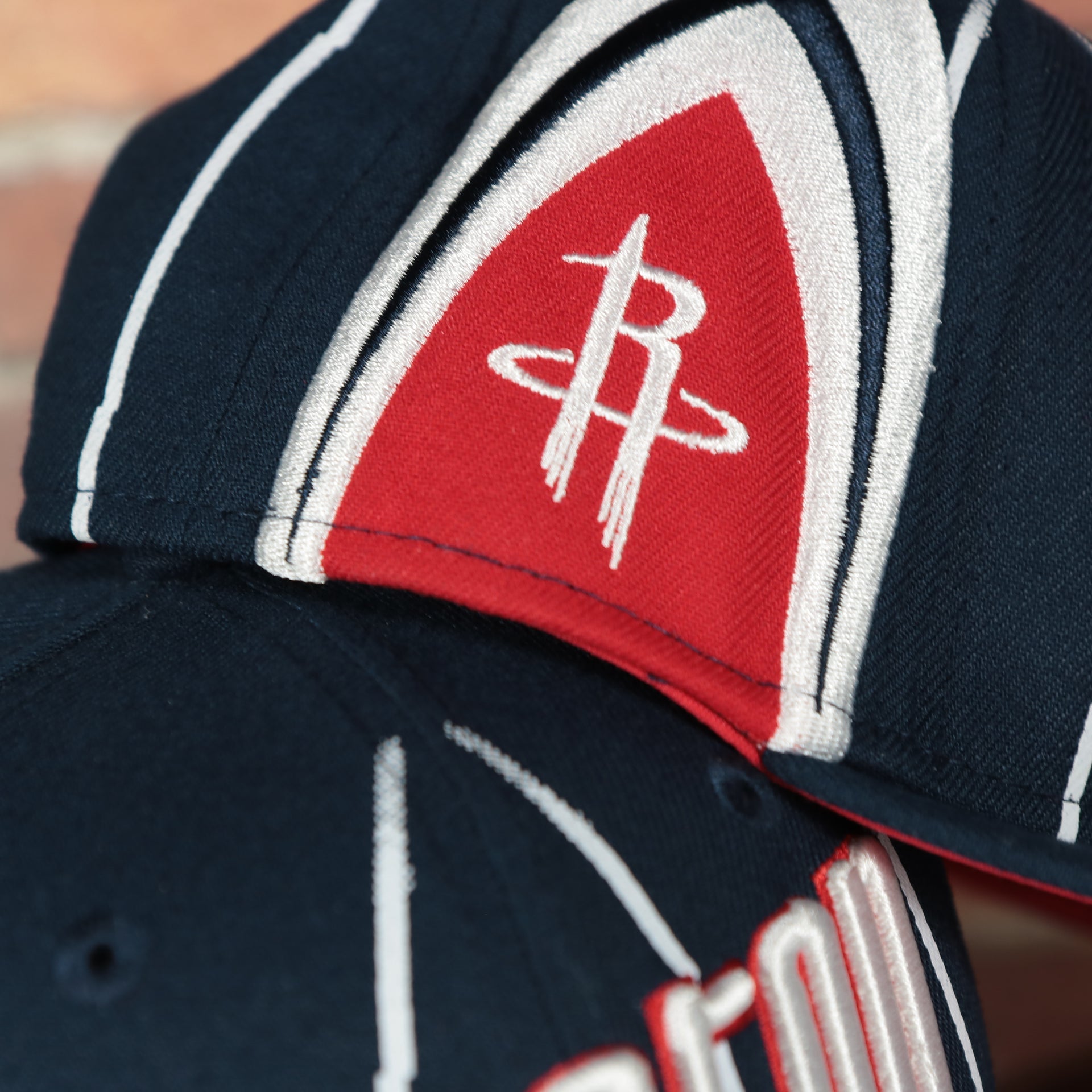 rockets logo on the wearers right side of the Houston Rockets 2022 City Edition Retro Houston Red Bottom Youth 9Fifty Side Patch Snapback Cap | New Era, Navy