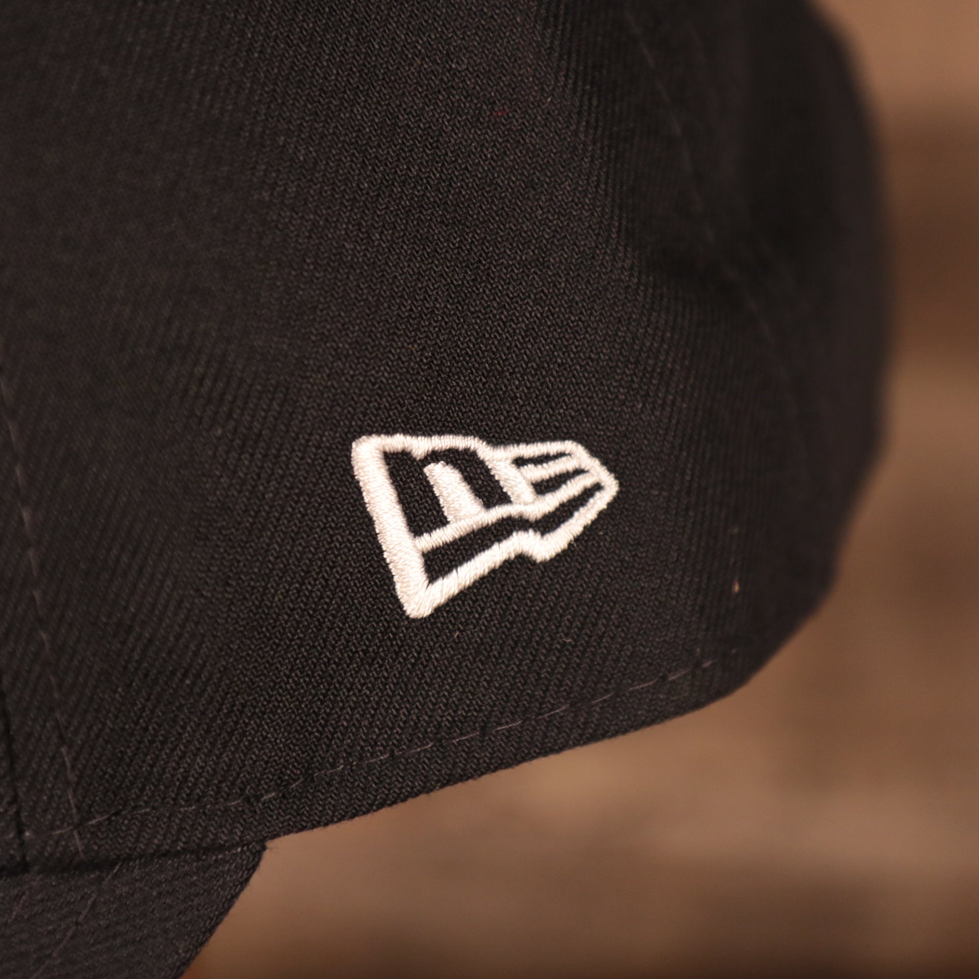 Close up of the New Era logo on the back of the Penn State Nittany Lions The League 940 9Forty Adjustable Dad Hat