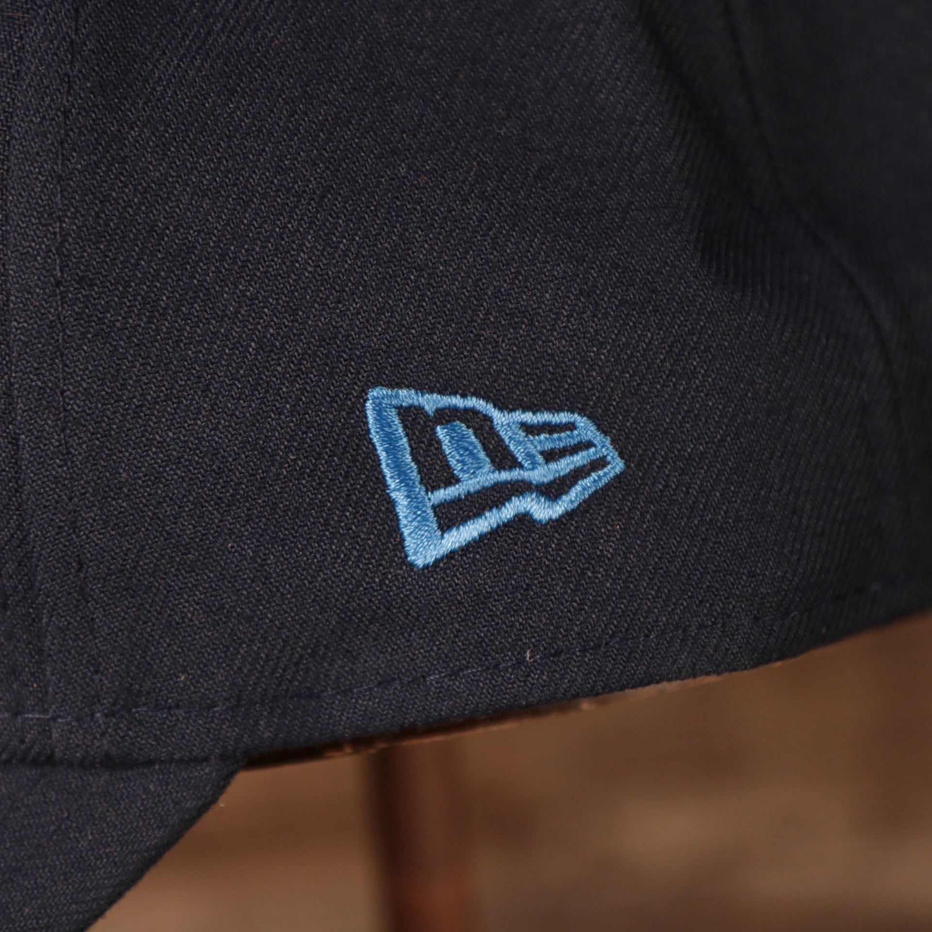 Close up of the New Era logo on the Los Angeles Chargers The League 940 9Forty Adjustable Dad Hat