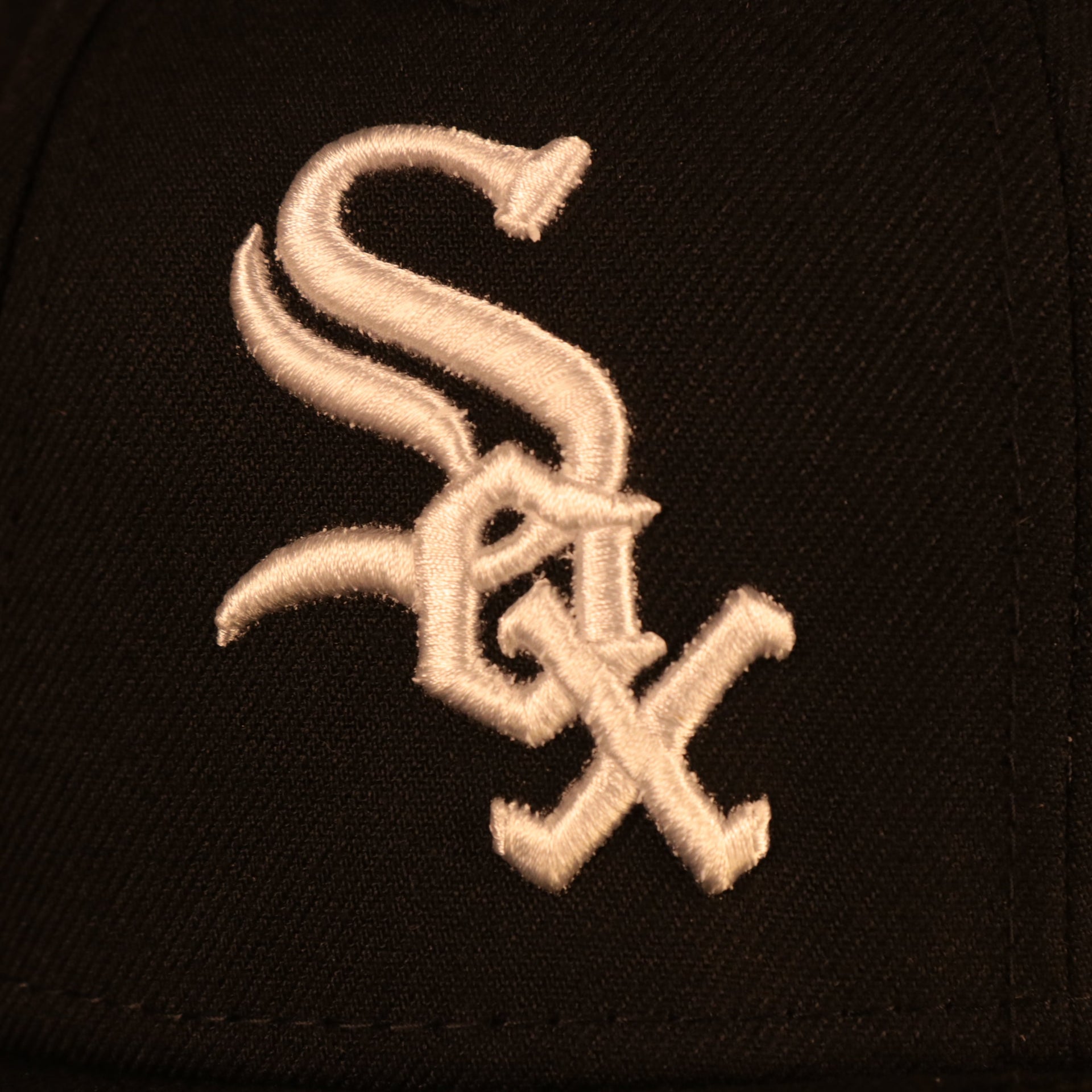 Close up of the White Sox logo on the Chicago White Sox "Pride Patch" All Over Gray Bottom Side Patch 59Fifty Fitted Cap