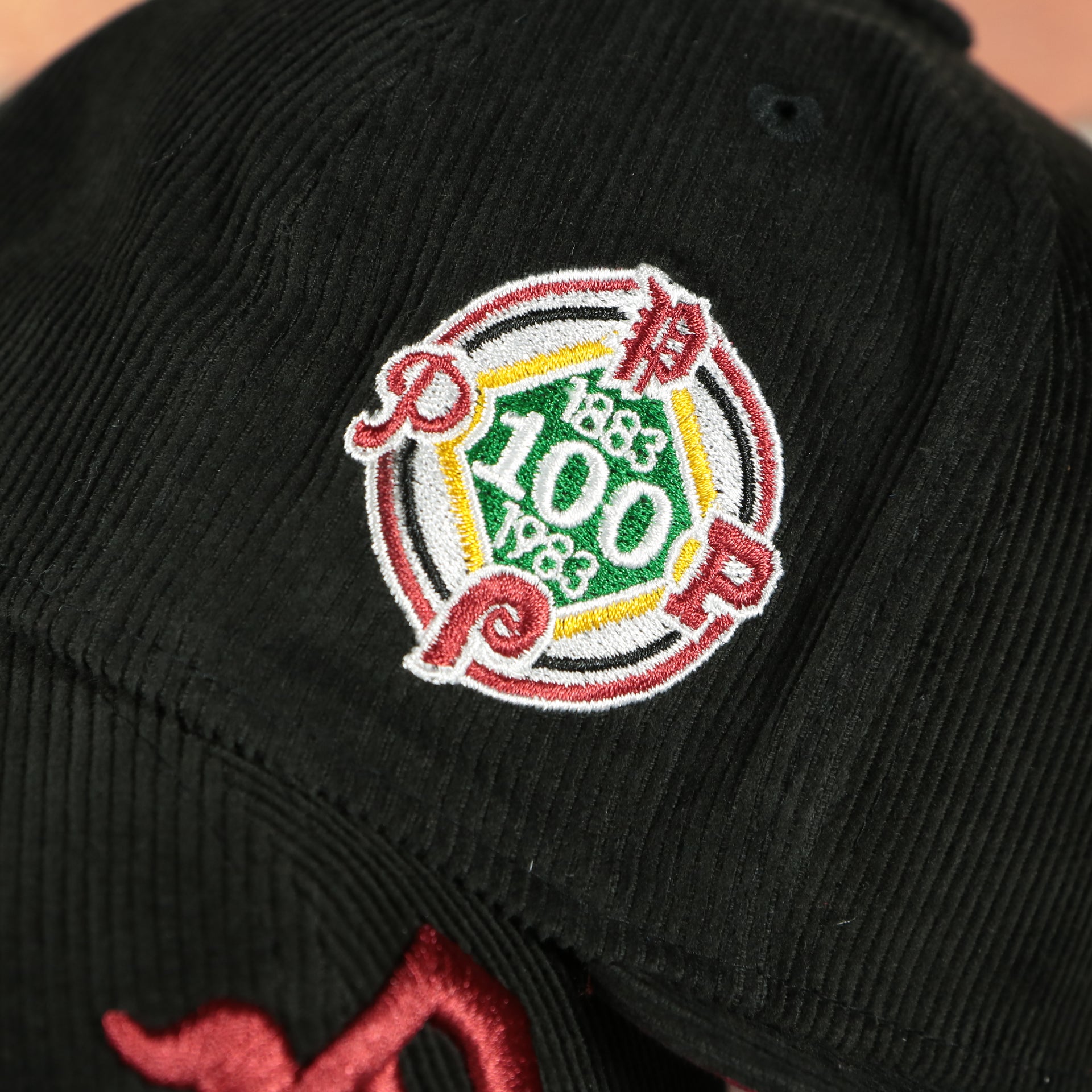 100th anniversary patch on the Philadelphia Phillies Cooperstown 100th Anniversary Side Patch Black Corduroy Maroon Bottom 59Fifty Fitted Cap | Corduroy Fitted Pack