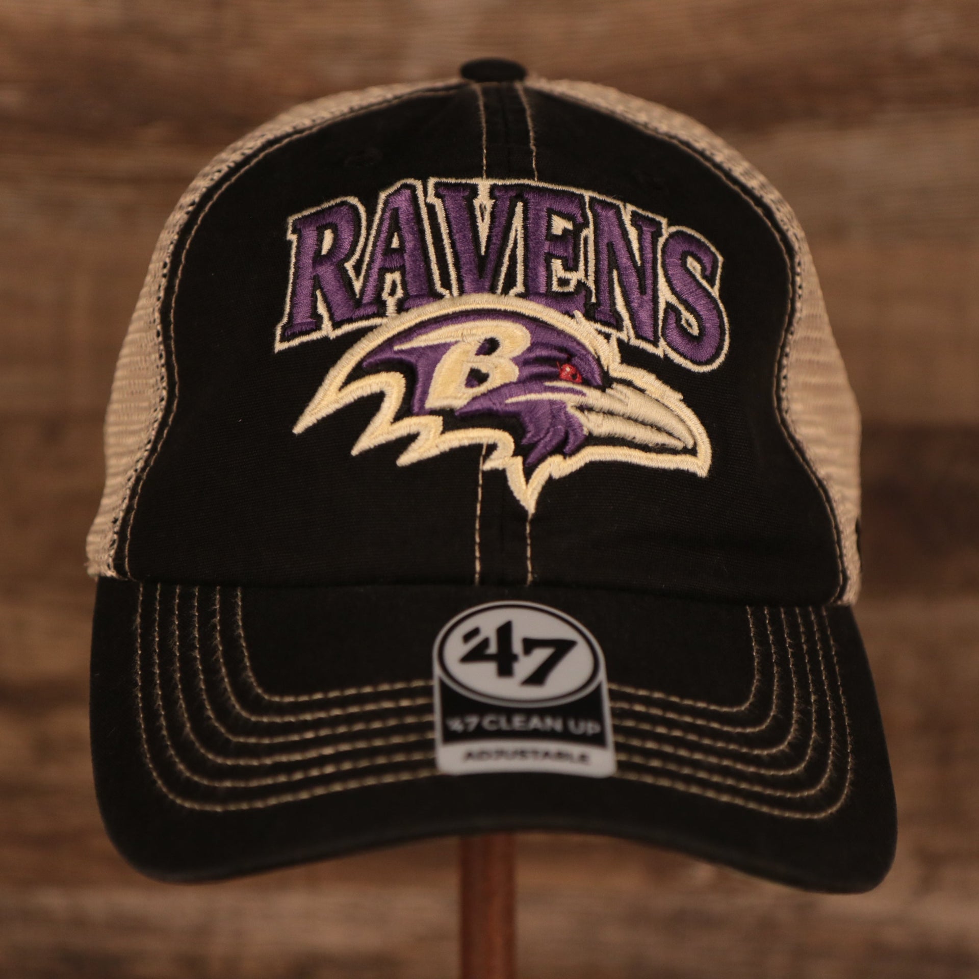 front of the Baltimore Ravens Black Adjustable Green Bottom Trucker Cap