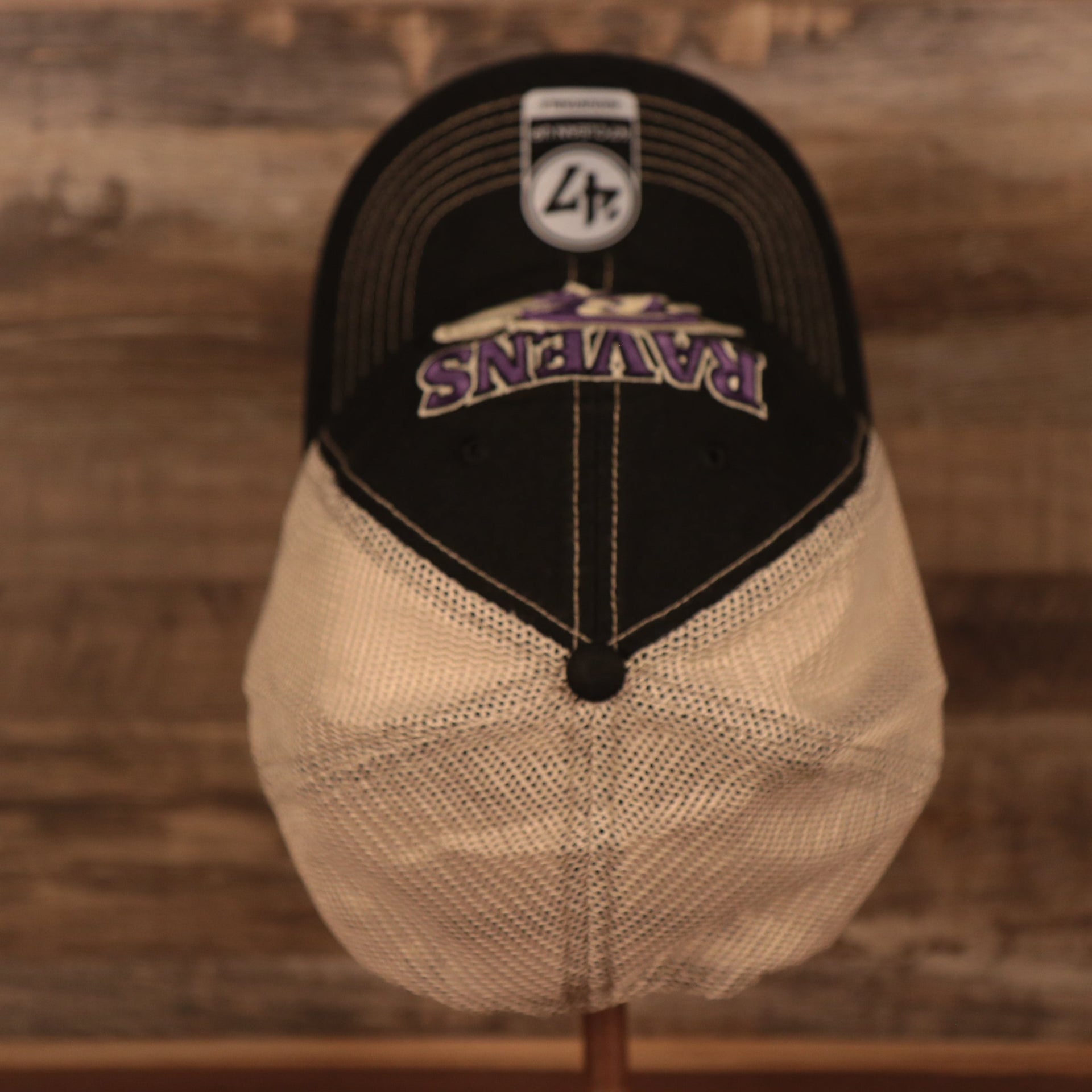 top view of the Baltimore Ravens Black Adjustable Green Bottom Trucker Cap