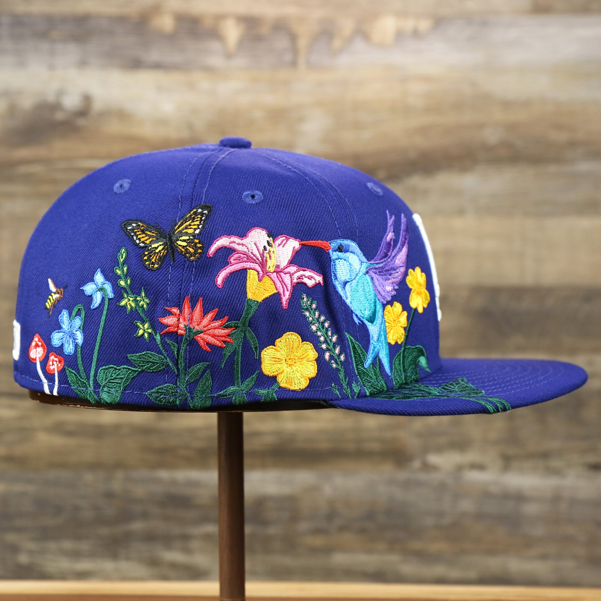 The wearer's right on the Los Angeles Dodgers Gray Bottom Bloom Spring Embroidery 59Fifty Fitted Cap | Royal Blue 59Fifty Cap