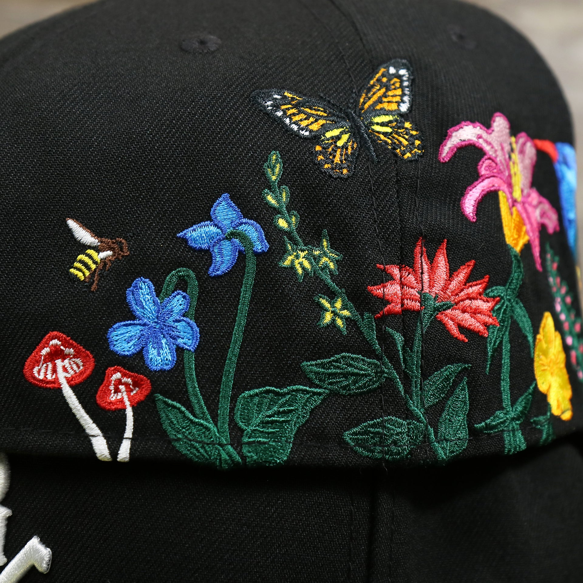 The backside of the bloom patch on the Chicago White Sox Gray Bottom Bloom Spring Embroidery 59Fifty Fitted Cap | Black 59Fifty Cap