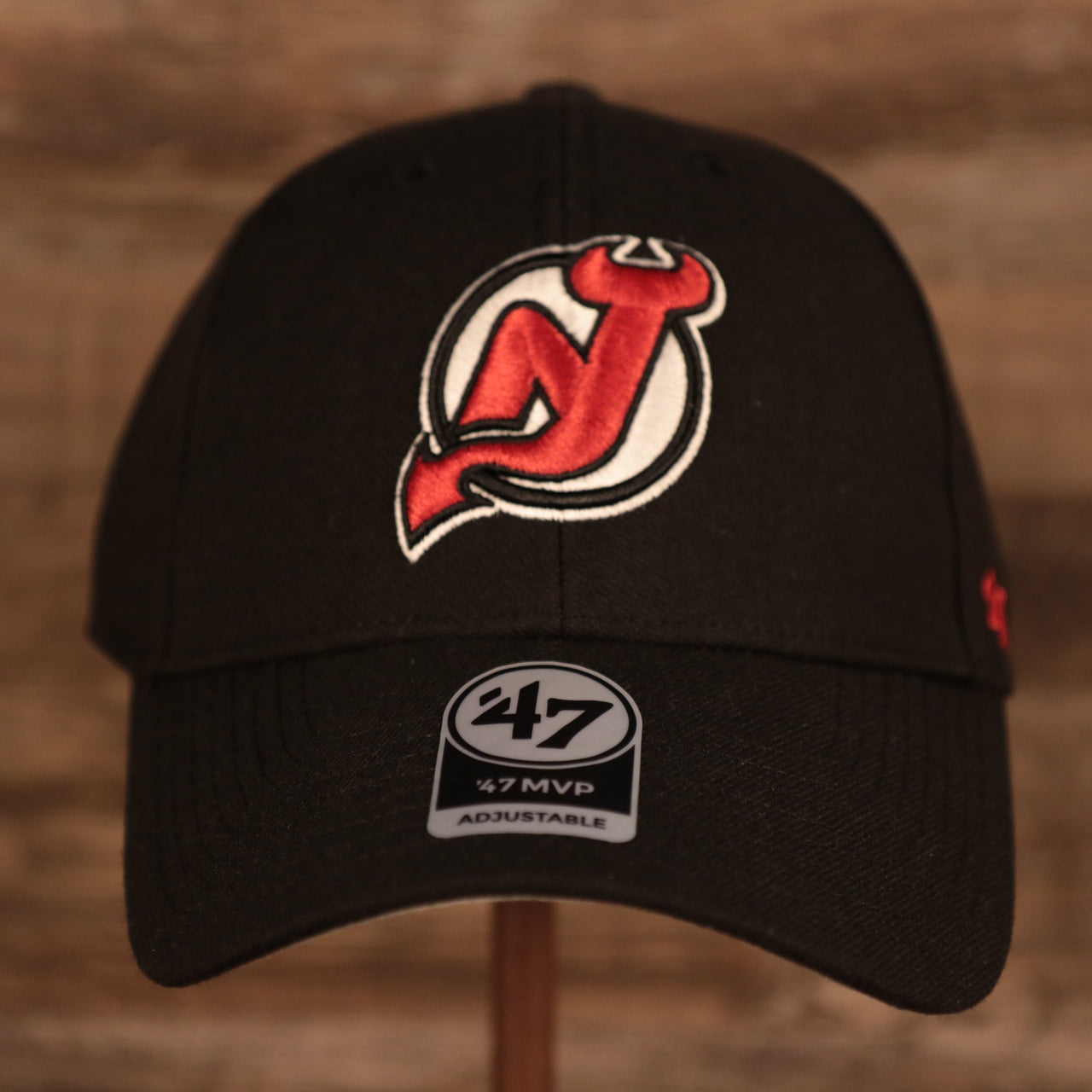 front of the New Jersey Devils Black Adjustable Dad Hat