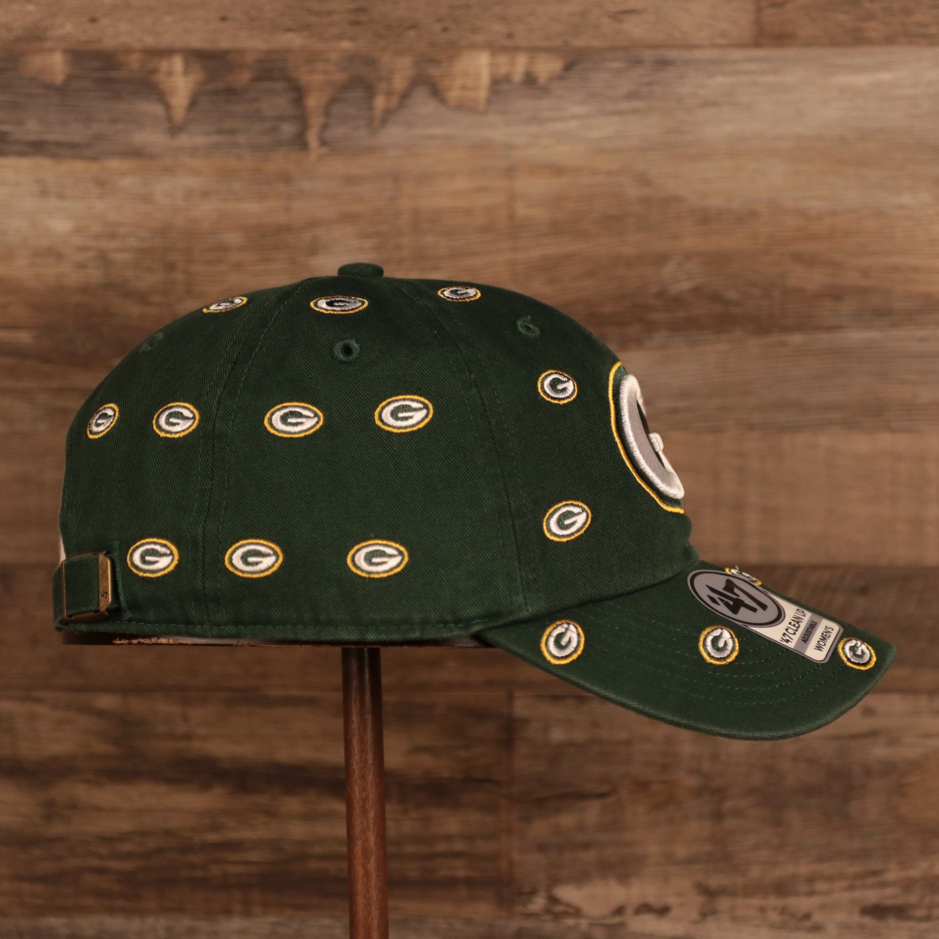 wearers right side of the Green Bay Packers All Over Logo Patch Green Adjustable Dad Hat