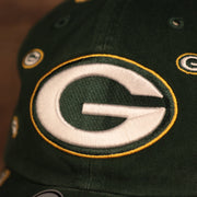 logo shot on the front of the Green Bay Packers All Over Logo Patch Green Adjustable Dad Hat
