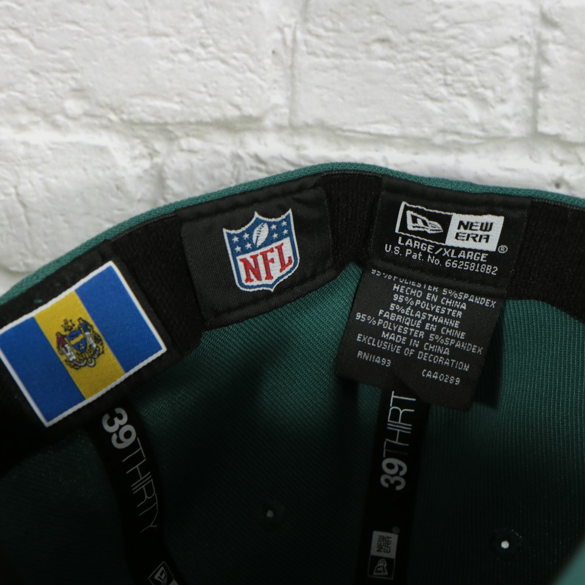 NFL label on the Philadelphia Eagles 2019 NFL Draft Team Color Midnight Green 39Thirty Flexfit Cap