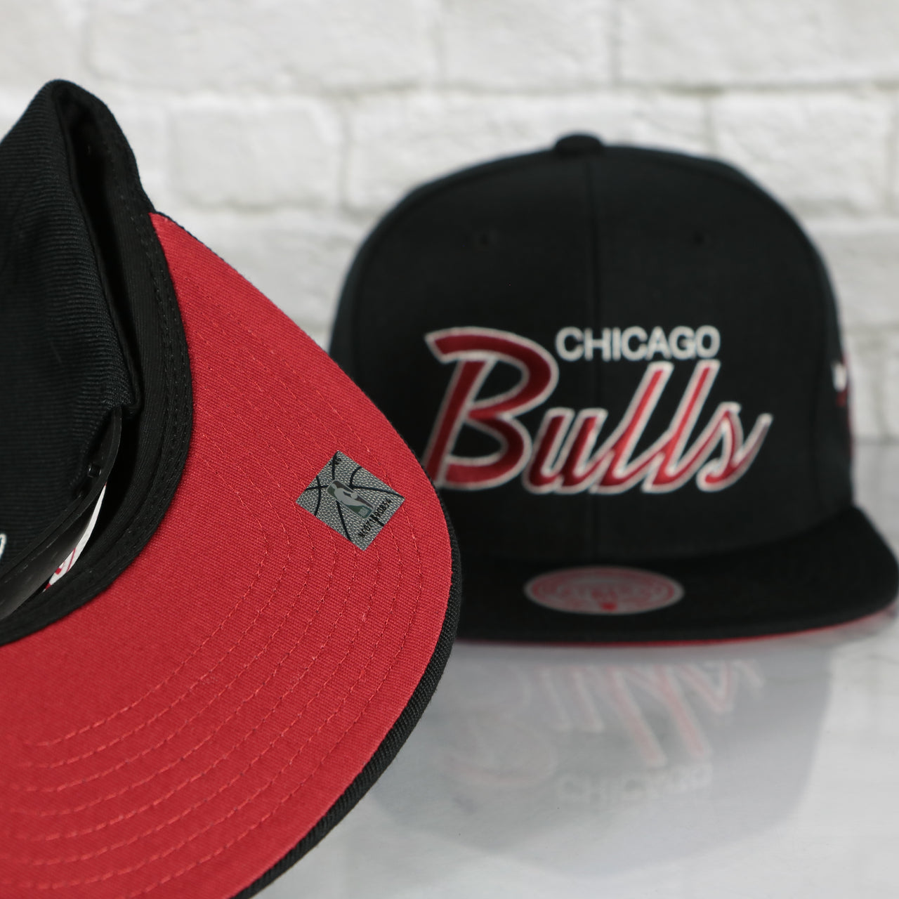 red under visor on the Chicago Bulls Vintage Retro NBA Team Script 2.0 Mitchell and Ness Snapback Hat | Black