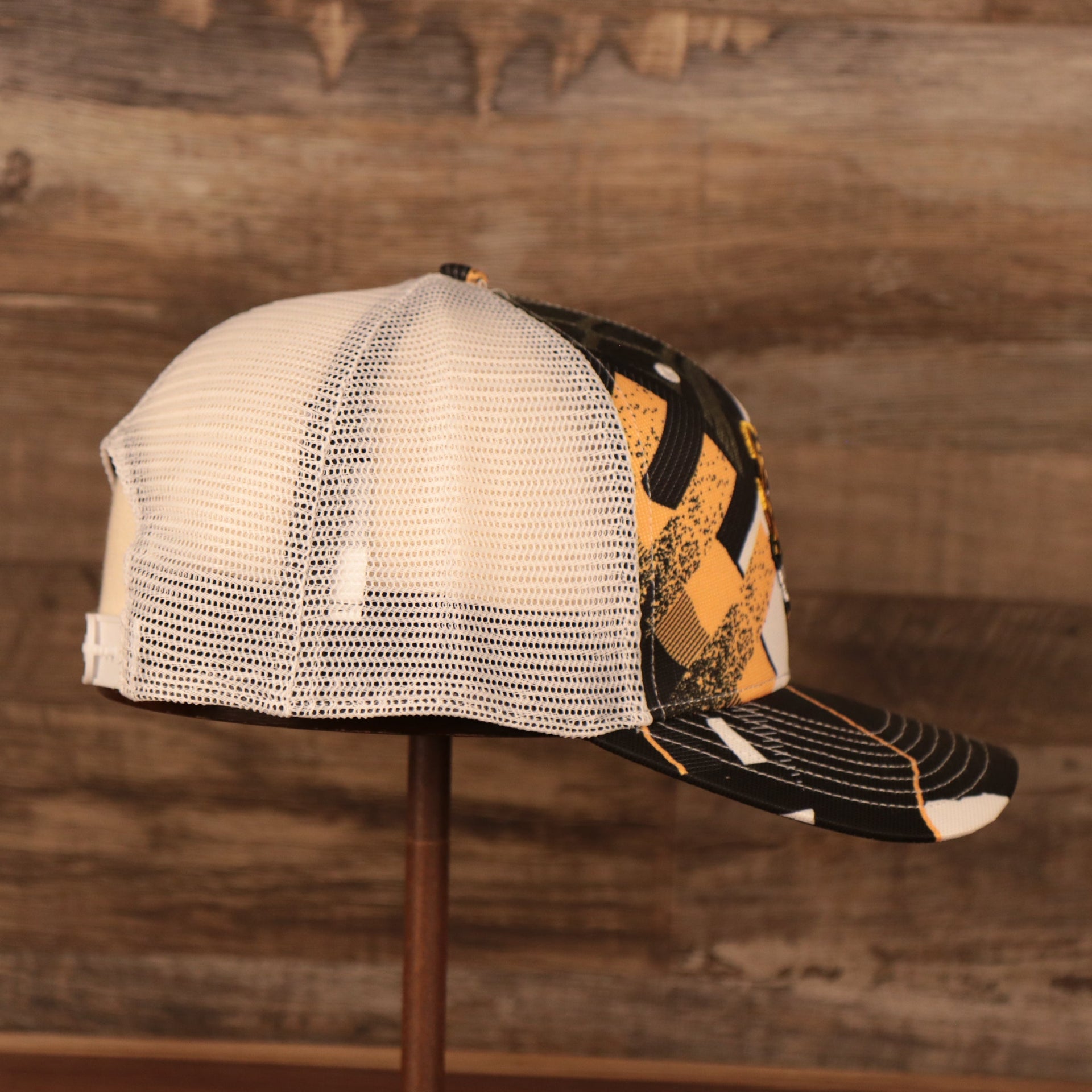 wearers right side of the Boston Bruins Brown, White, and Yellow Retro Adjustable Trucker Dad Hat