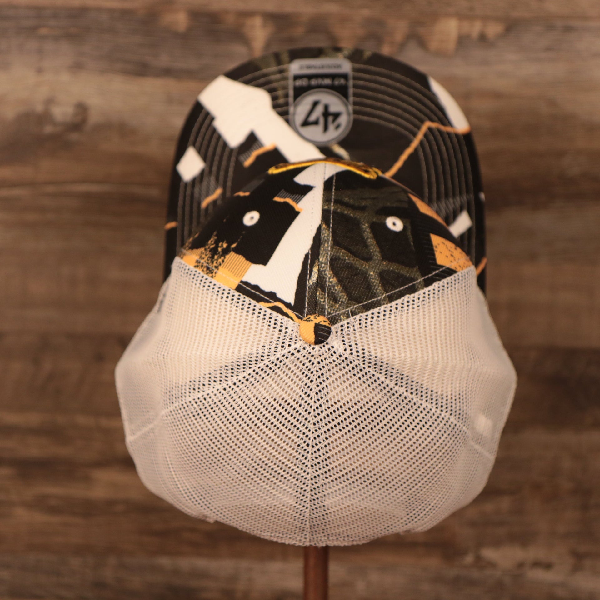 top of the Boston Bruins Brown, White, and Yellow Retro Adjustable Trucker Dad Hat