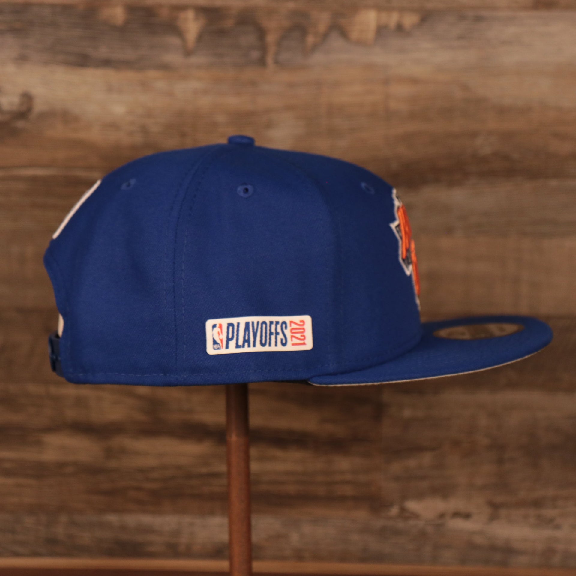 Embroidered on the wearer's right side of the New York Knicks 2021 NBA Playoffs snapback hat is the NBA 2021 Playoffs Side Patch