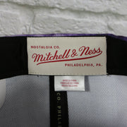 mitchell and ness label ont he Toronto Raptors Galaxy Purple Reflective Script Mitchell and Ness Snapback Hat