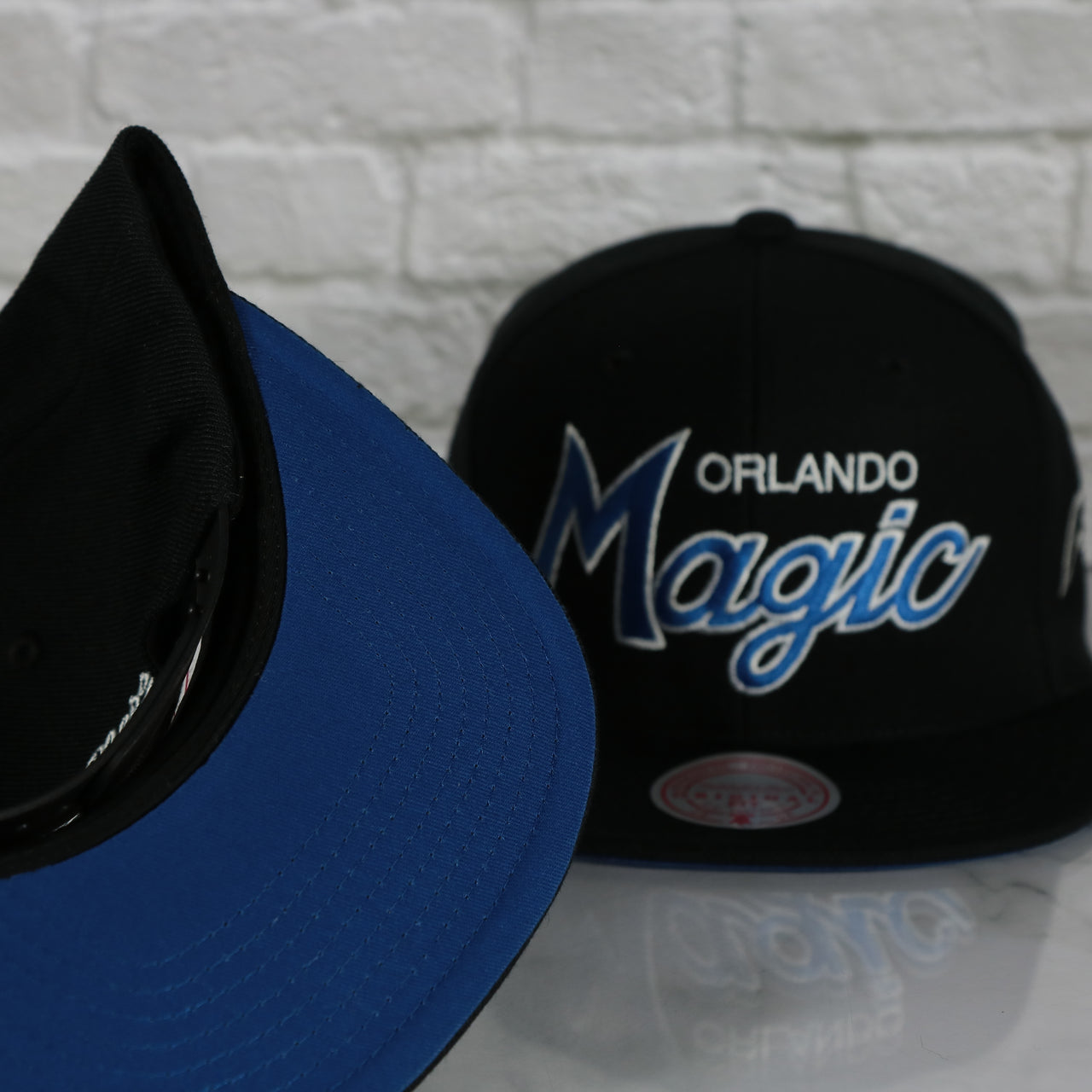 blue under visor on the Orlando Magic Vintage Retro NBA Team Script 2.0 Mitchell and Ness Snapback Hat | Black