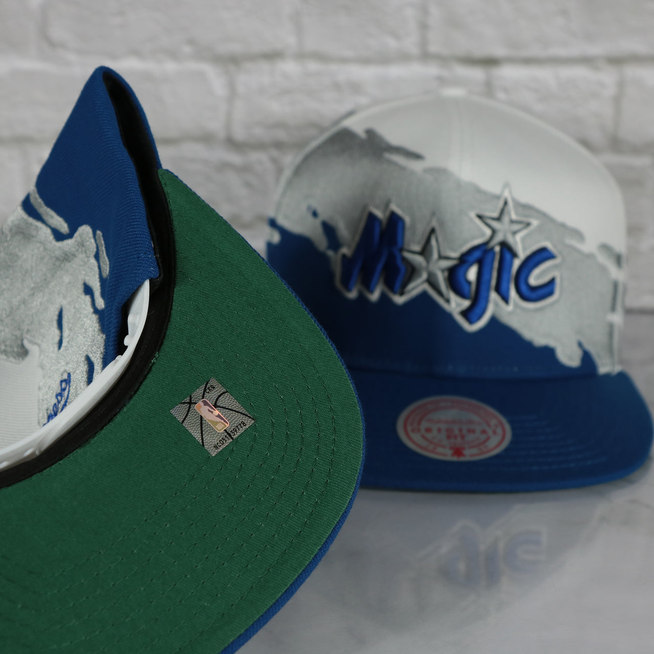 green under visor on the Orlando Magic Vintage Retro NBA Paintbrush Mitchell and Ness Snapback Hat | Blue/White/Silver