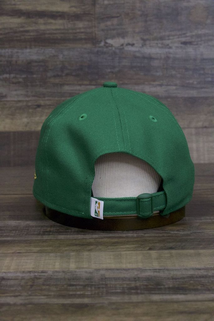 the back of the Boston Celtics 2019 City Series Dad Hat | Irish Green Adjustable Boston Celtics Baseball Cap with Golden Shamrock has a matching NBA tag on the strap