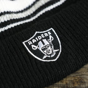 raiders logo on the Kid’s Oakland Raiders Striped Cuffed Winter Beanie With Pom Pom | Kid’s  Black And Gray Winter Beanie