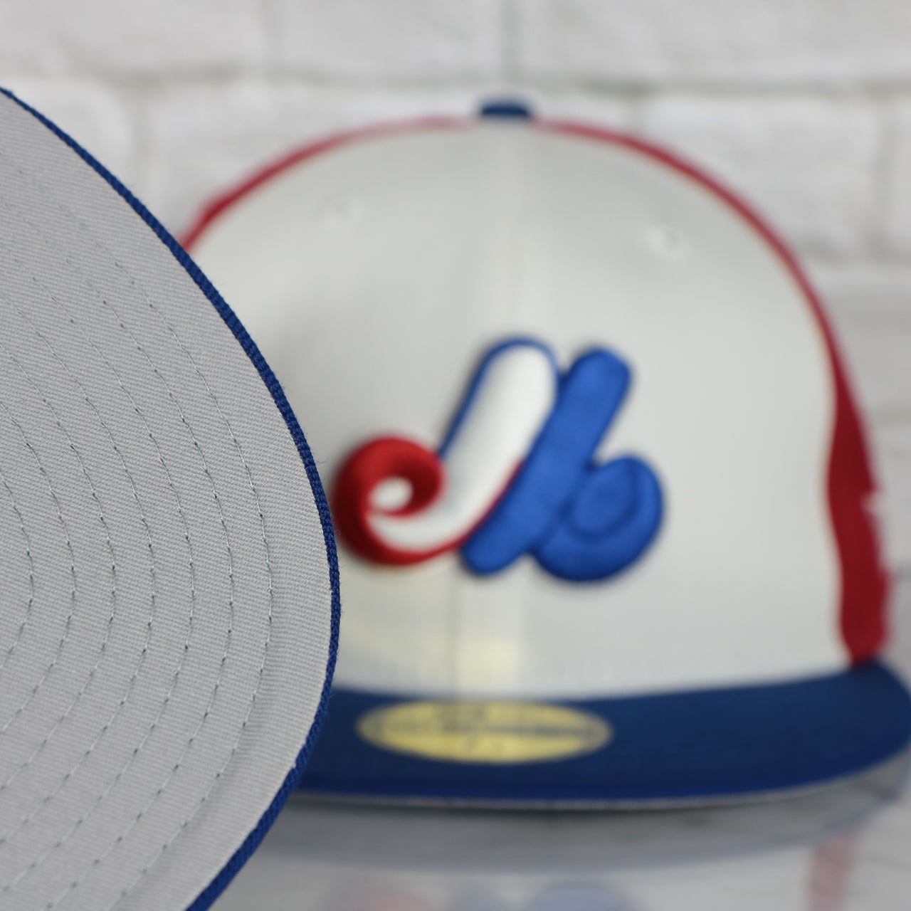 grey under visor on the Cooperstown Montreal Expos Gray Bottom Tri Colored 59Fifty Fitted Cap | Red, Blue, And White 59Fifty Cap