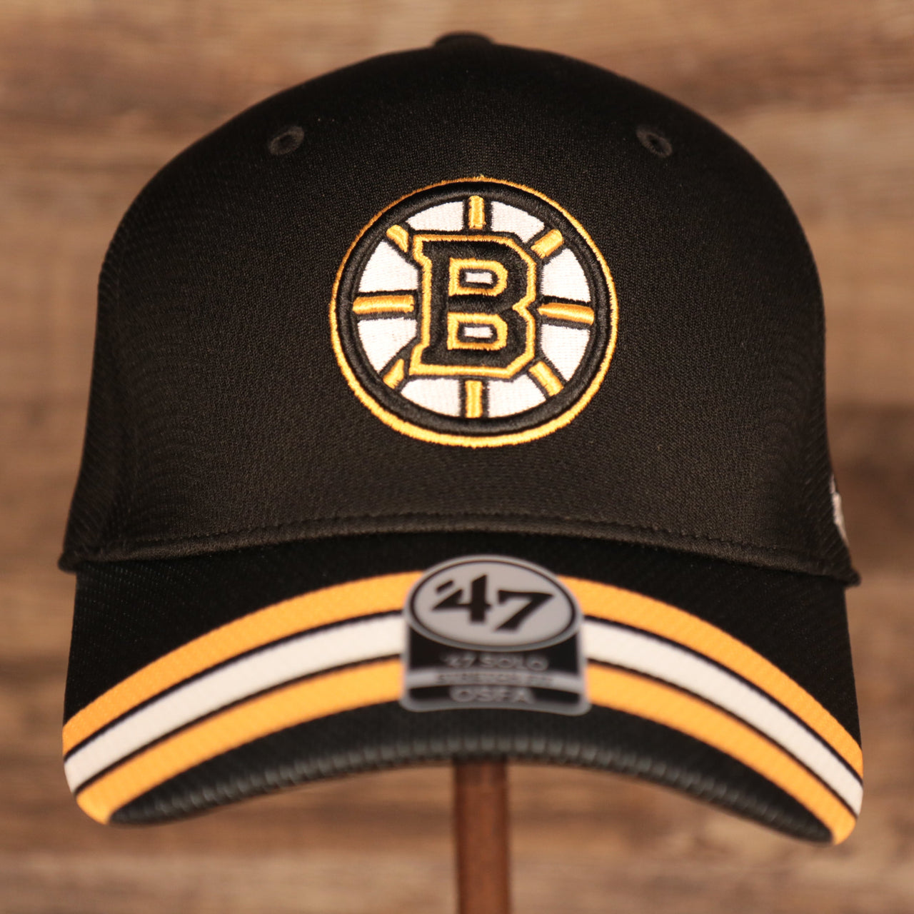 front of the Boston Bruins Black & Yellow Stretch Fit Dad Hat