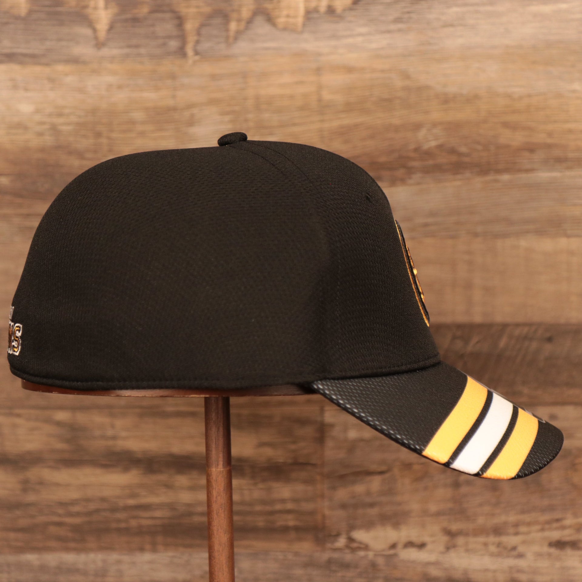 wearers right side of the Boston Bruins Black & Yellow Stretch Fit Dad Hat