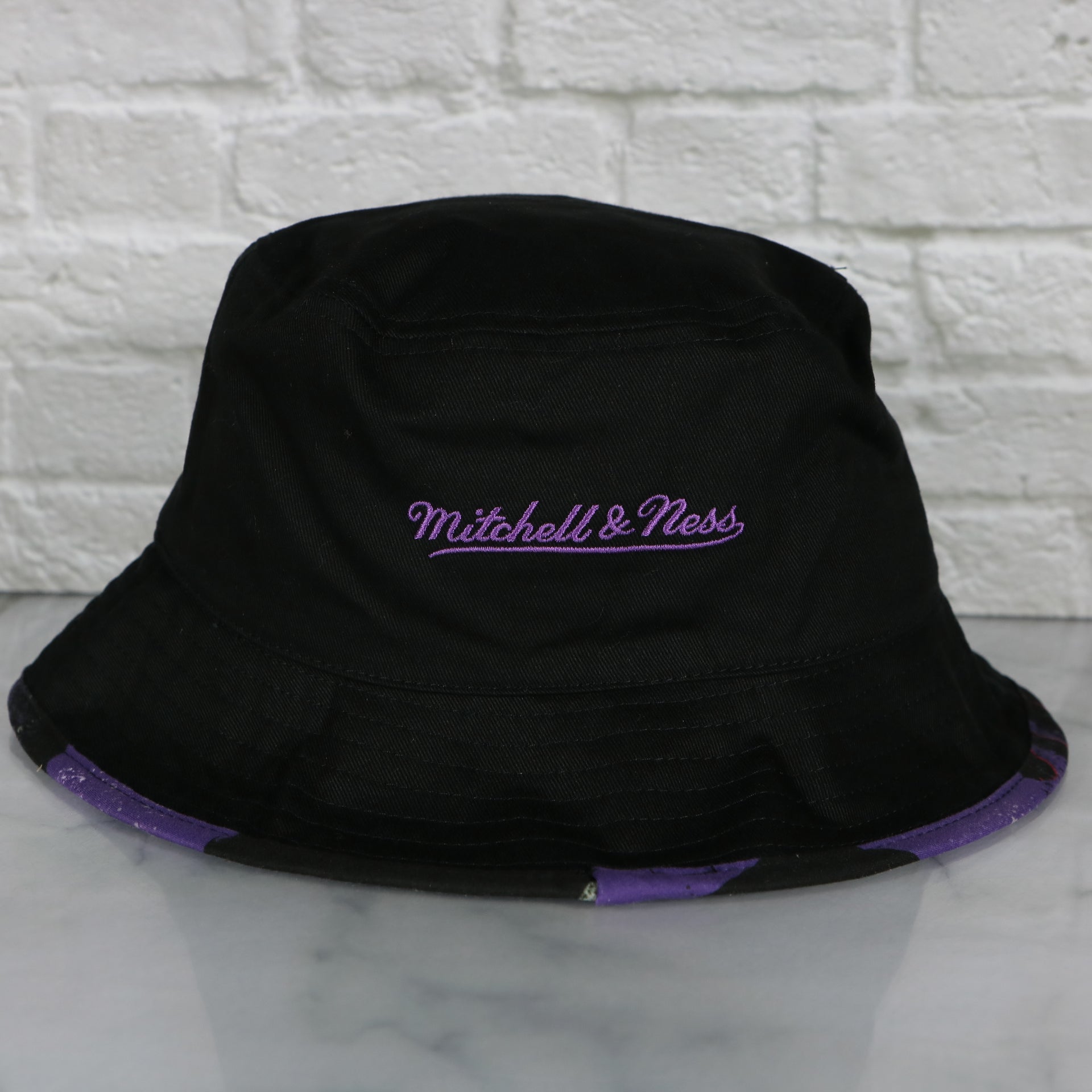 mitchell and ness logo on the Toronto Raptors 90s Inspired NBA Hyper Mitchell and Ness Reversible Bucket Hat